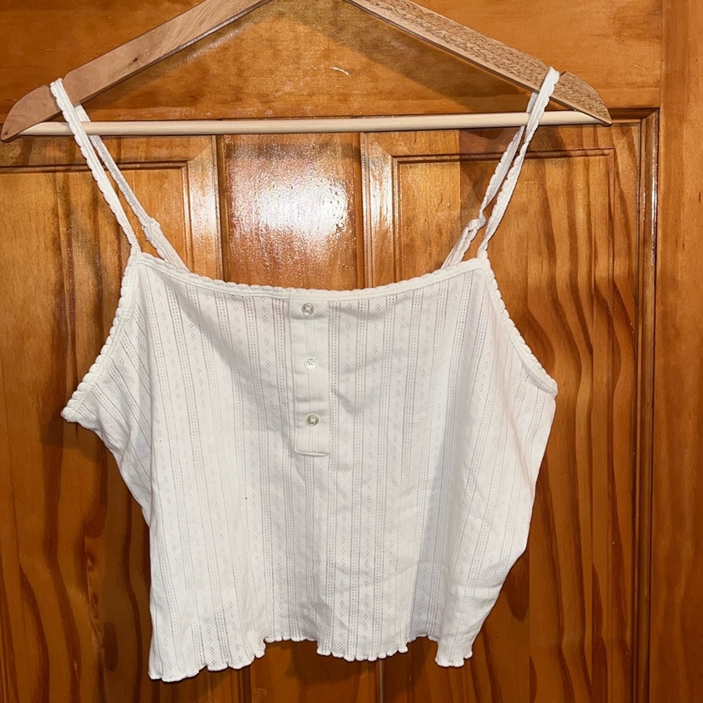 Small white tank top, worn 2-3 times only. Still in very good condition